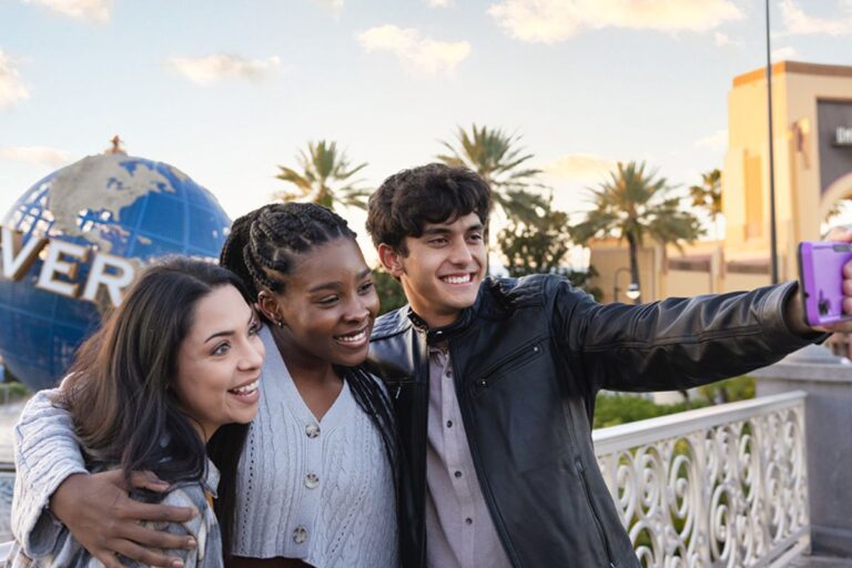 Fans pose for a selfie outside Universal Orlando.